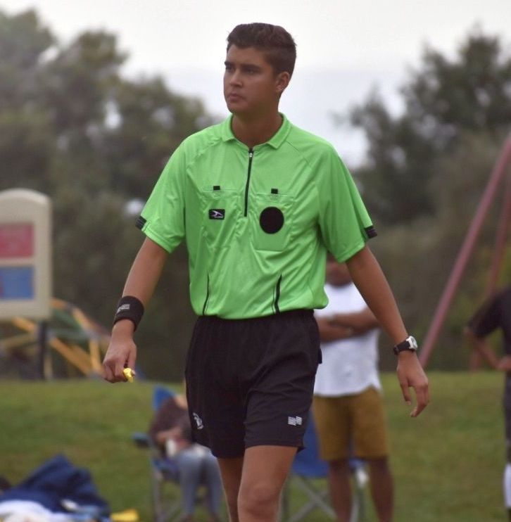 Alex Pena dans une chemise d'arbitre.