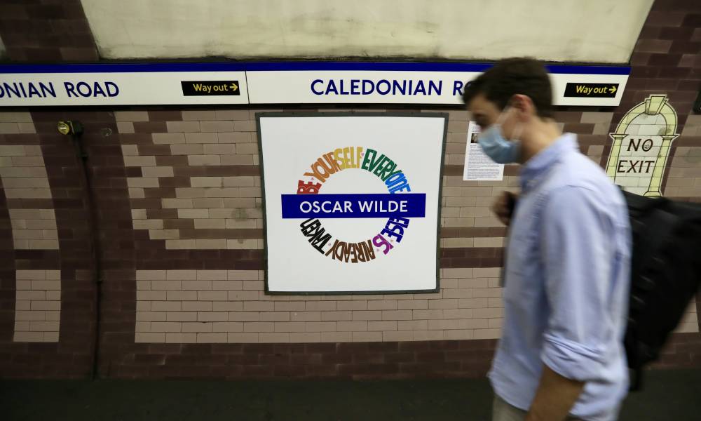 Une personne passe devant la cocarde du métro de Londres LGBT+ Pride conçue par Amy Lamé à la station Caledonian Road
