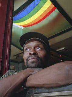 L'homme regarde par la fenêtre.