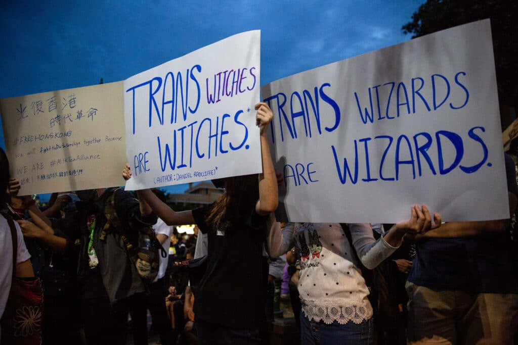 Les manifestants tiennent des pancartes appelant JK.  Les commentaires Twitter de Rowling