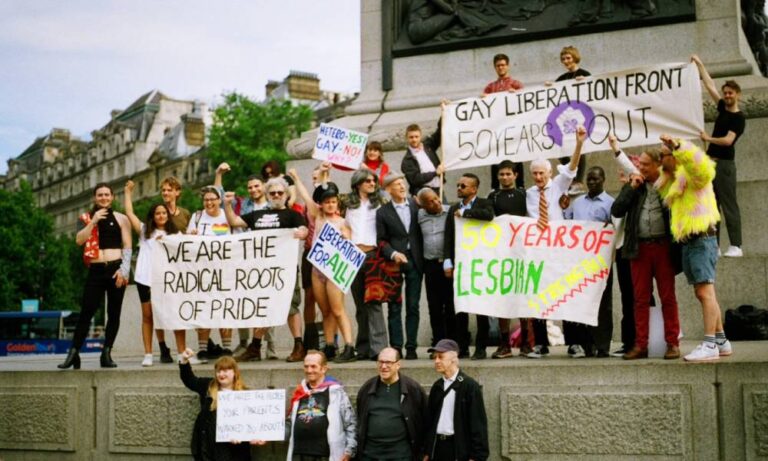 Members of the Gay Liberation Front (GLF) hold up signs during a protest in 2019