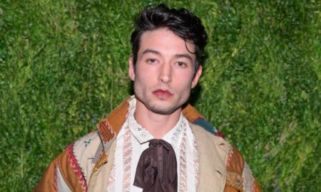 Actor Ezra Miller stares at the camera while wearing neutral coloured clothing