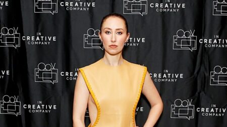 Actress Erin Doherty, dressed in long golden gown, attending the Prime Video screening of 'Chloe'.