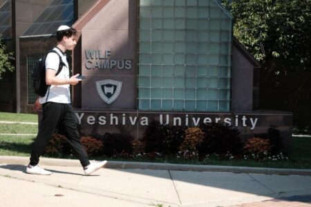 People walk by the campus of Yeshiva University in New York City on August 30, 2022.