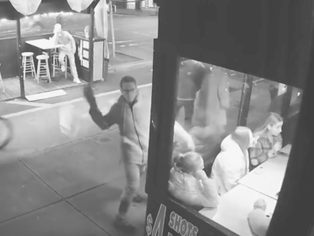 CCTV footage of man throwing a brick at window