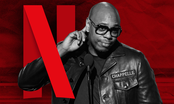 A graphic of comedian Dave Chappelle pointing to his ear as the red Netflix 'N' is wrapped around his arm.