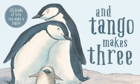 A cover of the book And Tango Makes Three featuring two adult penguins leaning into each other with a baby chick nestled in between them