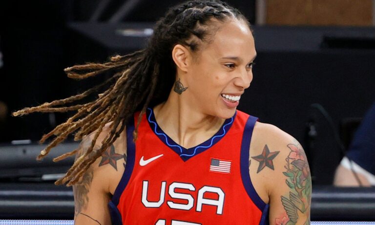 Brittney Griner smiles while wears a red, white and blue Team USA Olympic basketball jersey