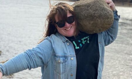 JayCee Cooper lifting a rock