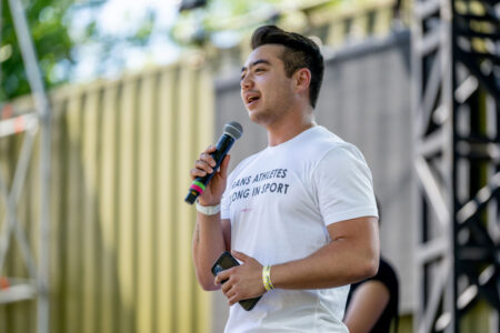 Schuyler wearing a shirt that says trans athletes belong in sport