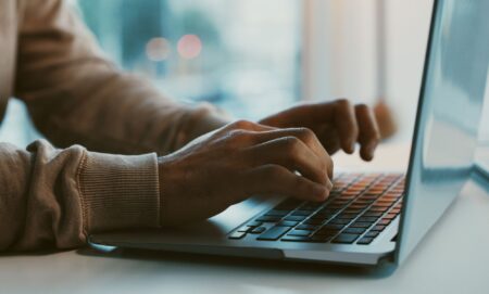 A person typing on a laptop.