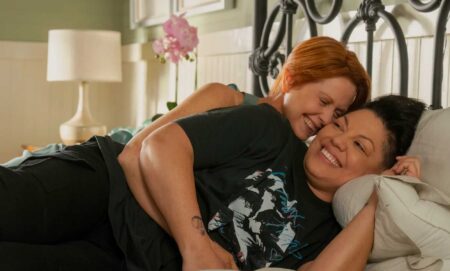 Cynthia Nixon as Miranda cuddling Sara Ramirez as Che Diaz in bed in season two of And Just Like That