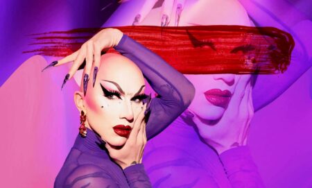 Sasha Velour in a sheer purple top holding her face with her hands.