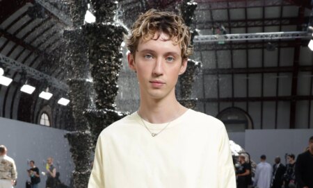 Troye Sivan in a white jumper dress at Paris Fashion Week.