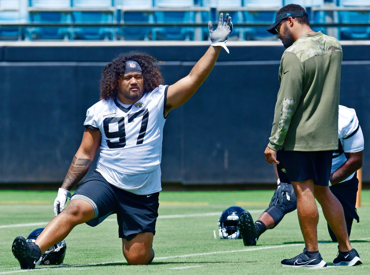L'entraîneur associé des Jaguars de Jacksonville, Kevin Maxen, travaille avec le plaqueur défensif Jay Tufele lors de la session du minicamp des recrues des Jaguars en juin 2022.