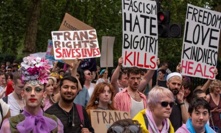 An activist holds up a sign reading