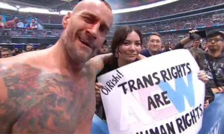 CM Punk with a fan holding a sign that reads