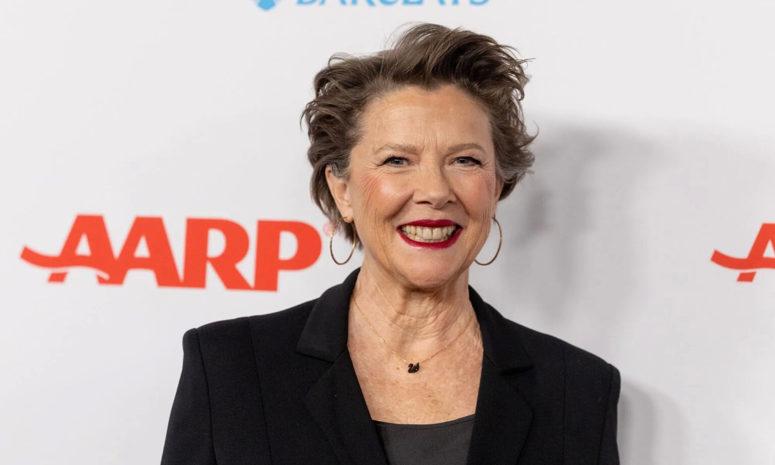 Annette Bening rend un hommage sincère à son fils trans Stephen : « Une telle inspiration » Annette Bening in a black blazer and top smiling at the camera while on the red carpet.