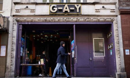 A person walks past the G-A-Y bar and venue in London, England