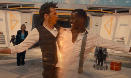 A screenshot of David Tennant and Ncuti Gatwa from the BBC series Doctor Who where Tennant and Gatwa are connected and being pulled apart