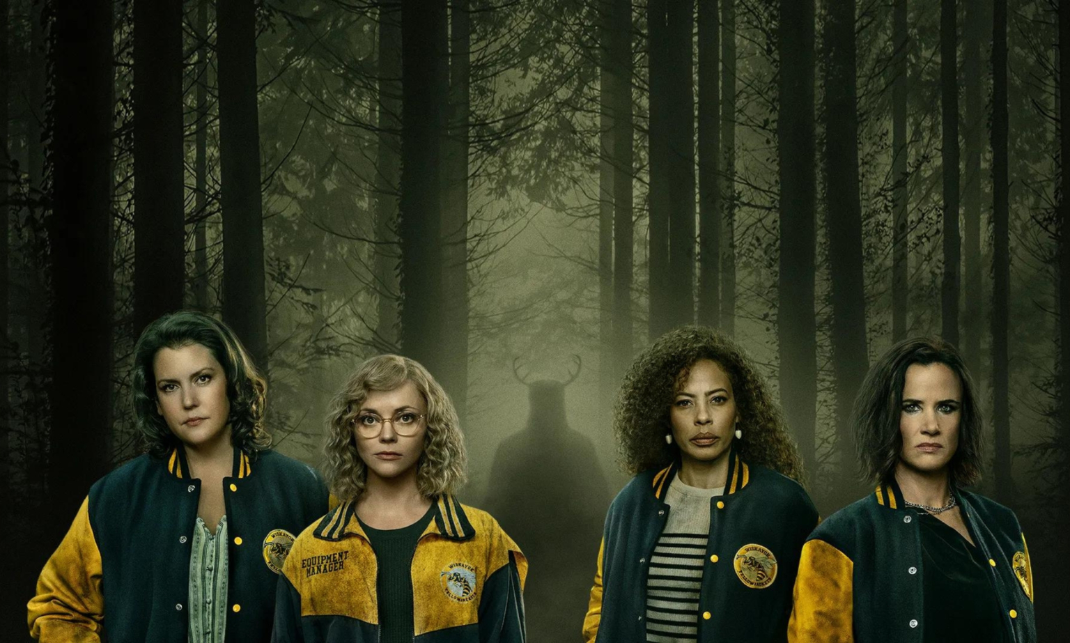 Voici ce que nous savons de la troisième saison des Yellowjackets The cast of Yellowjackets in the woodland with a silhouette with horns behind them.