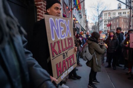 People gather outside the Stonewall Inn for a memorial and vigil for the Oklahoma teenager who died following a fight in a high school bathroom on February 26, 2024 in New York City. Nex Benedict, a 16-year-old who identified as nonbinary and used they/them pronouns, died a day after the altercation in the school bathroom. One protester is holding a sign that says