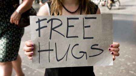 Stock image of a woman holding a sign reading