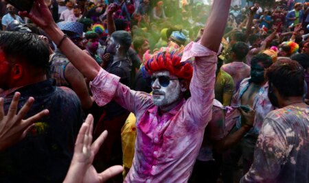 People take part in the celebrations to mark Holi, the Hindu spring festival of colours at Assi Ghat in Varanasi on March 25, 2024. (Photo by Niharika KULKARNI / AFP)