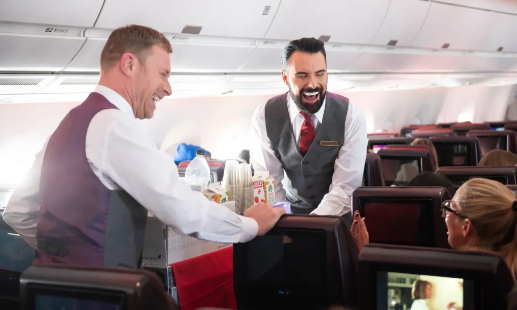 Il s'agit d'une image de Rylan Clark distribuant une boisson sur un vol Virgin Atlantic.