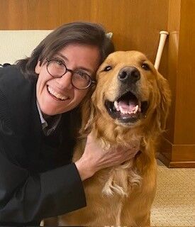 Une image de la juge Ana C. Reyes serrant son chien dans ses bras