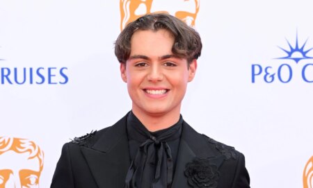 Bradley Riches on the red carpet of the BAFTA Awards smiling.