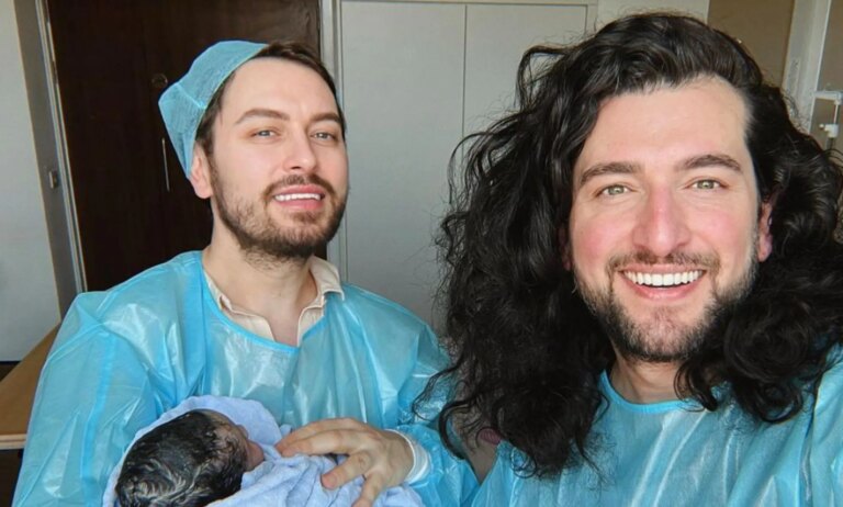 Brian Dowling (left) and Arthur Gourounlian (right) with their new baby