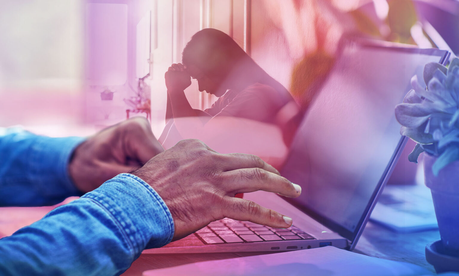 Devez-vous toujours vous mettre entièrement et authentiquement au travail ? In the foreground, a pair of black hands are typing at a computer. In the background there is a silhouette of a distressed person..