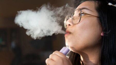 Stock image of a woman with a vape
