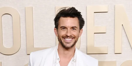 Jonathan Bailey on a white suit smiling