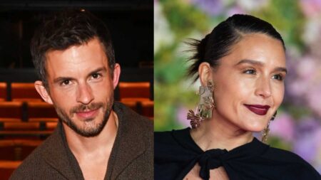 Jonathan Bailey poses onstage while Jessie Ware poses at the