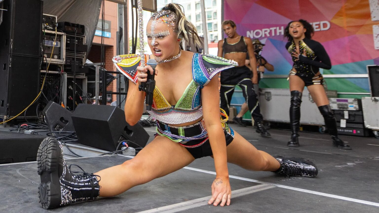 JoJo Siwa jumps in the air and drops into the splits during the Chicago Pride Fest on June 22, 2024 in Chicago, Illinois
