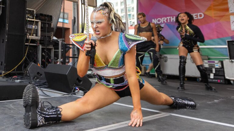 JoJo Siwa jumps in the air and drops into the splits during the Chicago Pride Fest on June 22, 2024 in Chicago, Illinois