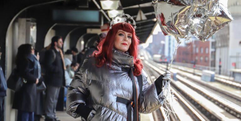 Ana Matronic at a train station holding a balloon