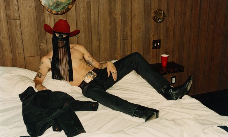Country singer Orville Peck, known for his signature fringed mask, has offered a glimpse of his face in a new photo shoot for The New York Times, coinciding with his upcoming Broadway debut in