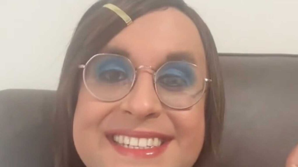 Trans teacher Rosie Sandri smiles widely at the camera.