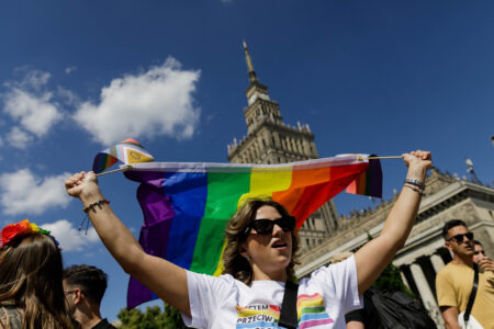 A participant holds a rainbow flag before the procession in Warsaw, Poland.
