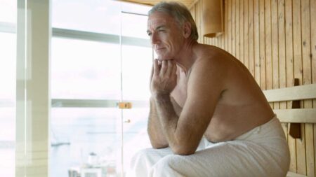 Man sitting in sauna.