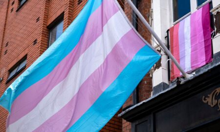 A trans flag on the side of a building.