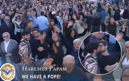 images taken from a clip of two men kissing outside the Vatican