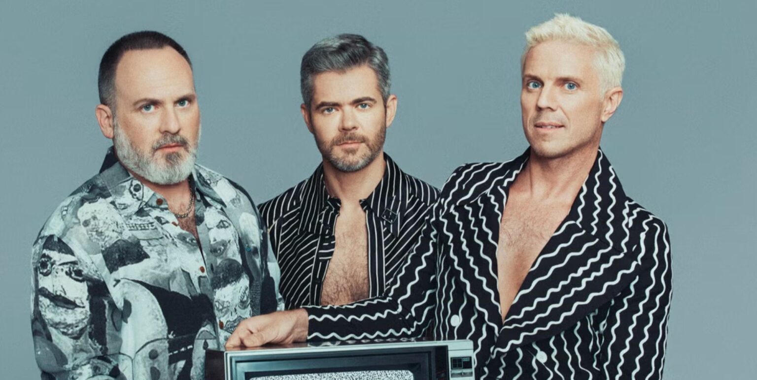 Babbydaddy, Del Marquis and Jake shears pose in grey outfits for a promo photo for the scissor sisters reunion.