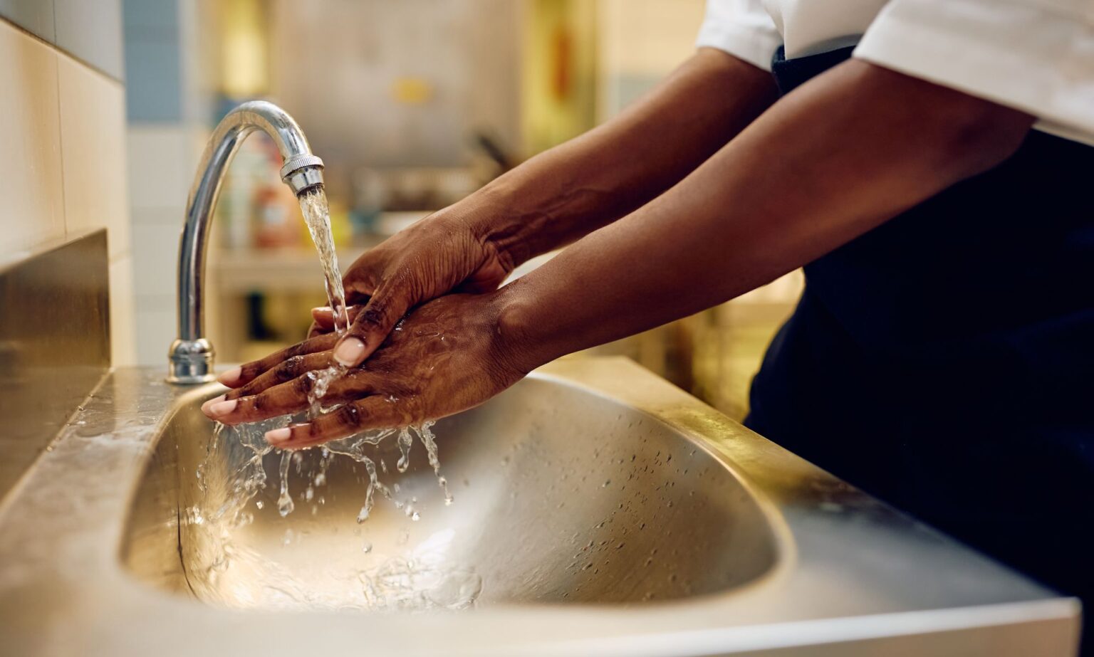 A person washing their hands.
