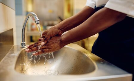 A person washing their hands.