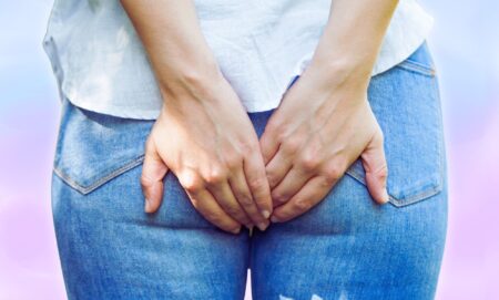 An edited picture of someone holding their rear-end.