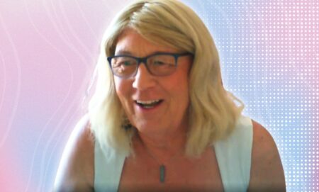 An edited picture of Anne Coombes over a trans gradient.